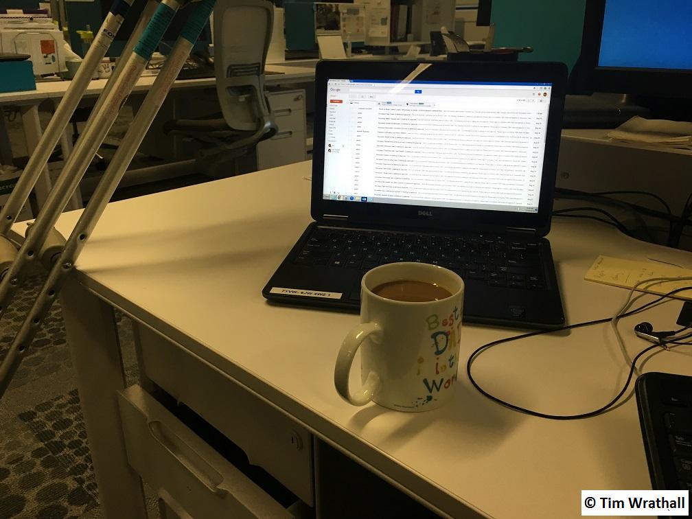 Day 1, back in the Office. Laptop, Coffee and Crutches.